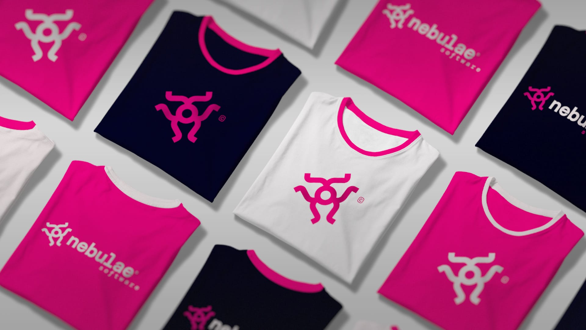 Flat lay of colorful t-shirts with the Nebulae Software logo on different backgrounds.